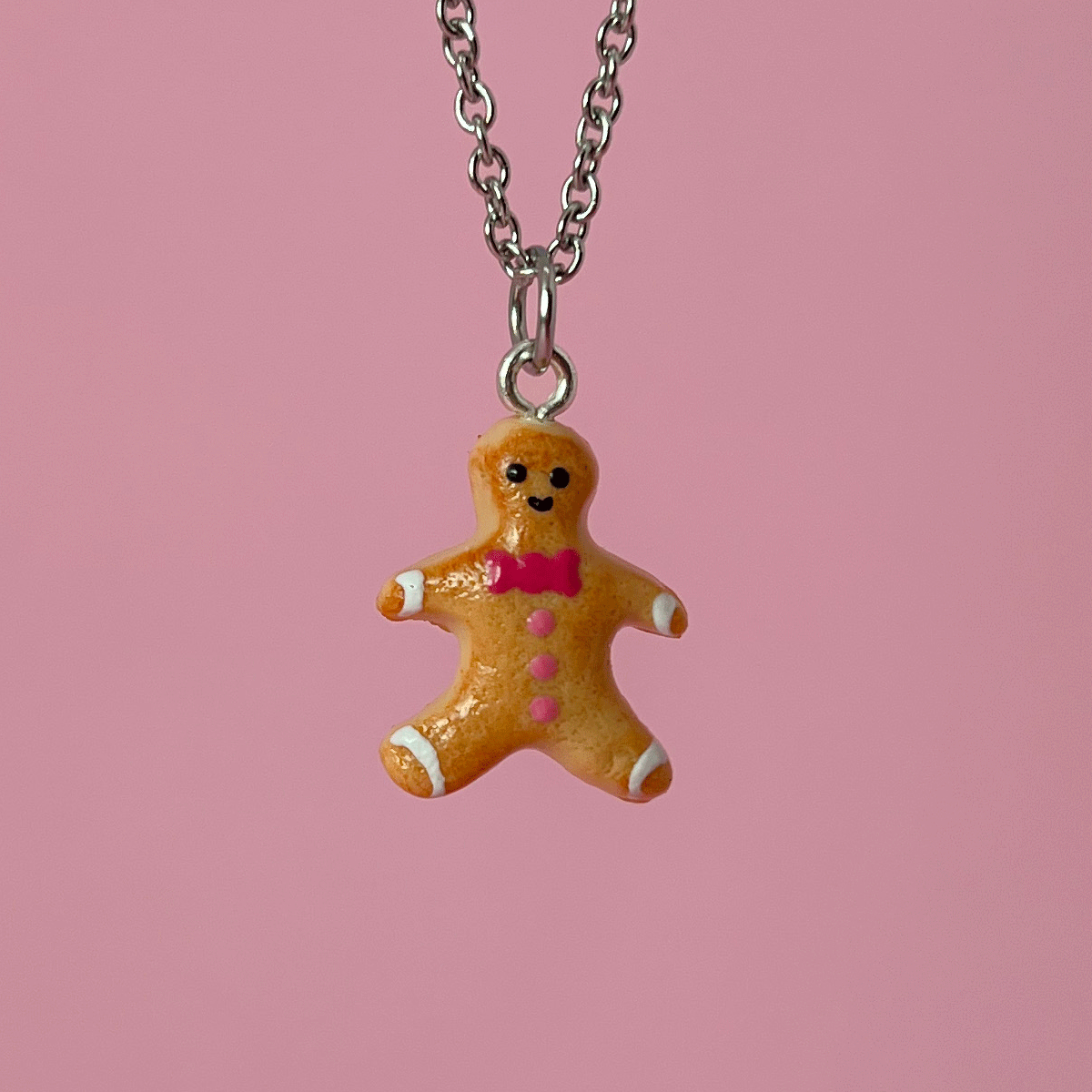 Collier - Biscuit Bonhomme pain d'épice avec noeud papillon rose
